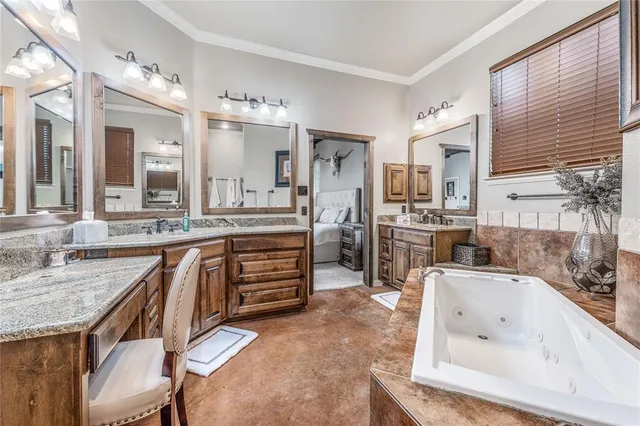 a large bathroom with double vanity and a bathtub
