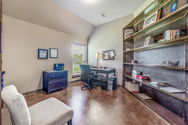 a reading room with furniture and a book shelf