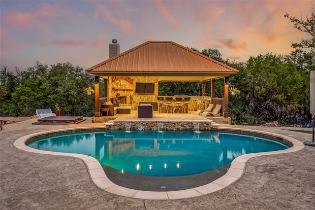 a view of swimming pool with outdoor seating