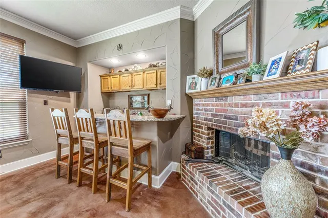 a dining room with furniture a rug and a flat screen tv