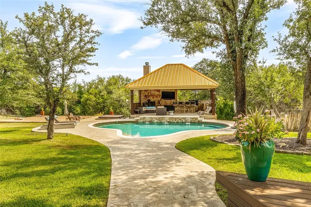 a swimming pool with outdoor seating and yard