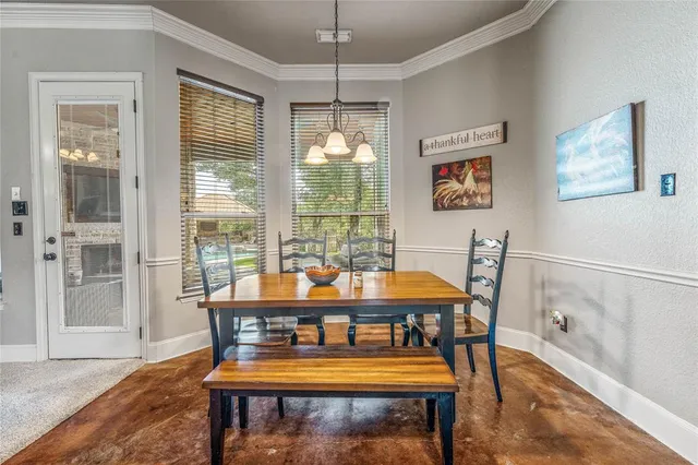 a dining room with furniture a rug and a large window
