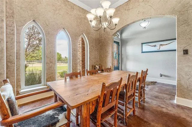 a view of a dining room with furniture wooden floor and chandelier
