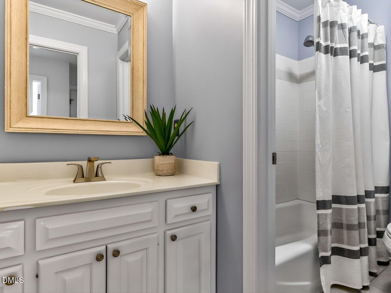 6104 Wolverhampton Drive Raleigh, NC 27603 - Photo 18 of 35 a bathroom with a granite countertop sink and a mirror