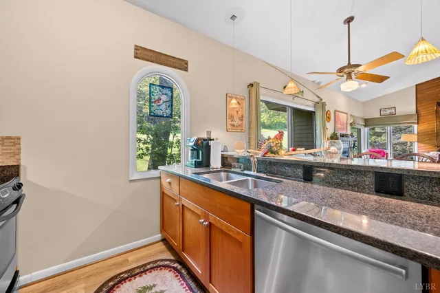 a kitchen with stainless steel appliances granite countertop a stove and a microwave
