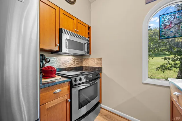a dining room with furniture a chandelier and wooden floor