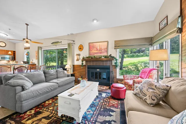 a living room with furniture and a floor to ceiling window