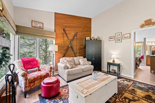 a living room with furniture and wooden floor