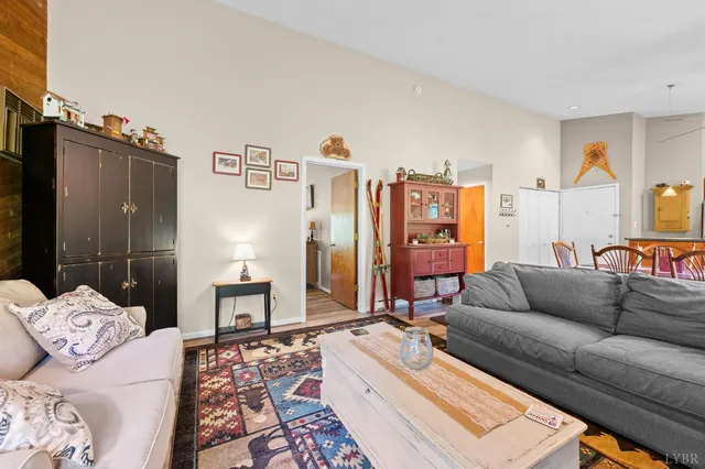 a bedroom with a bed a flat screen tv and a large window