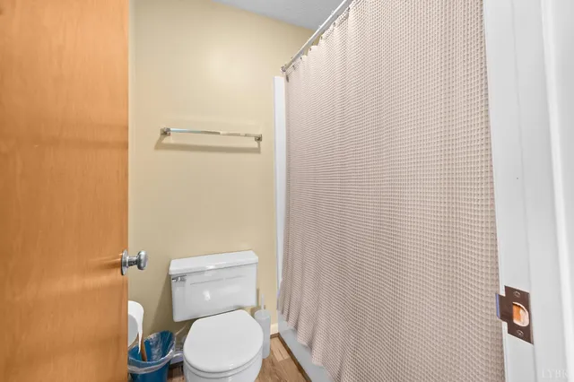 a view of a hallway with wooden floor and a living room