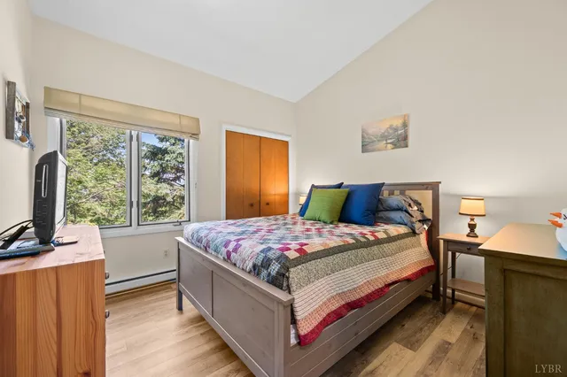 a bed sitting in a bedroom next to a window