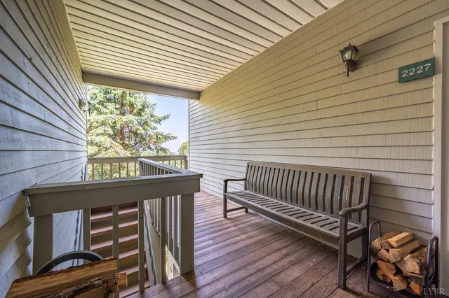 a view of a roof deck with wooden floor and fence