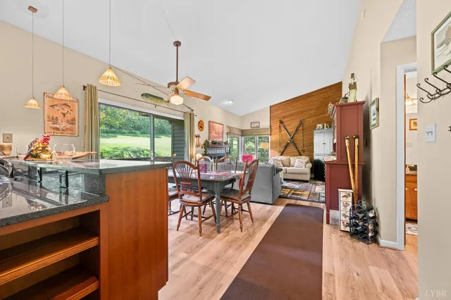 a kitchen with stainless steel appliances granite countertop a refrigerator and a table