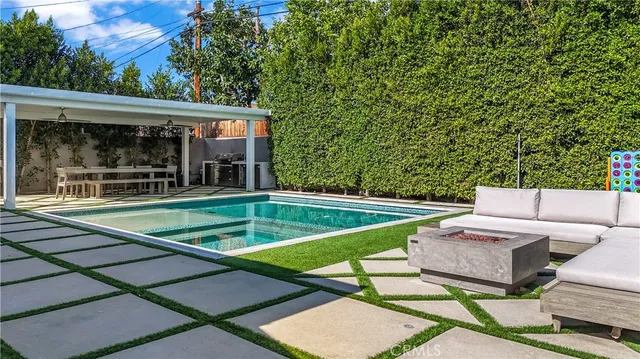 a view of a patio with chairs and a small yard