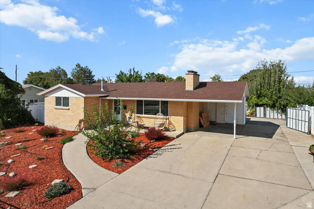 215 Carol Way Midvale, UT 84047 - Photo 1 of 30 Brick Rambler style home with an attached carport, concrete driveway, New shingled roof. Long RV pad