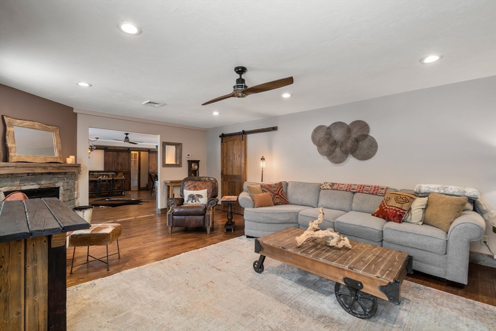 43 Ridge Way Sturbridge, MA 01566 - Photo 10 of 22 a living room with furniture and a flat screen tv with kitchen view