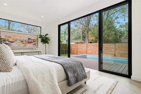 a bedroom with a large bed and a large window