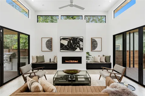 a living room with furniture and a floor to ceiling window