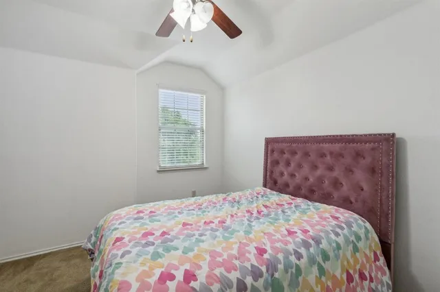 a bed room with a bed and a chandelier