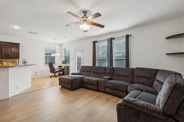 a living room with furniture and kitchen view