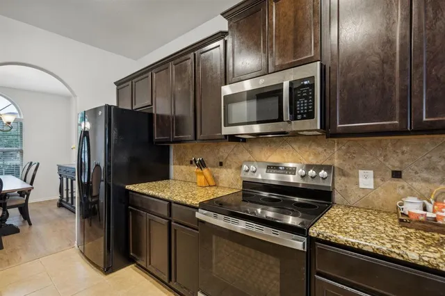 a dining room with furniture a chandelier and wooden floor