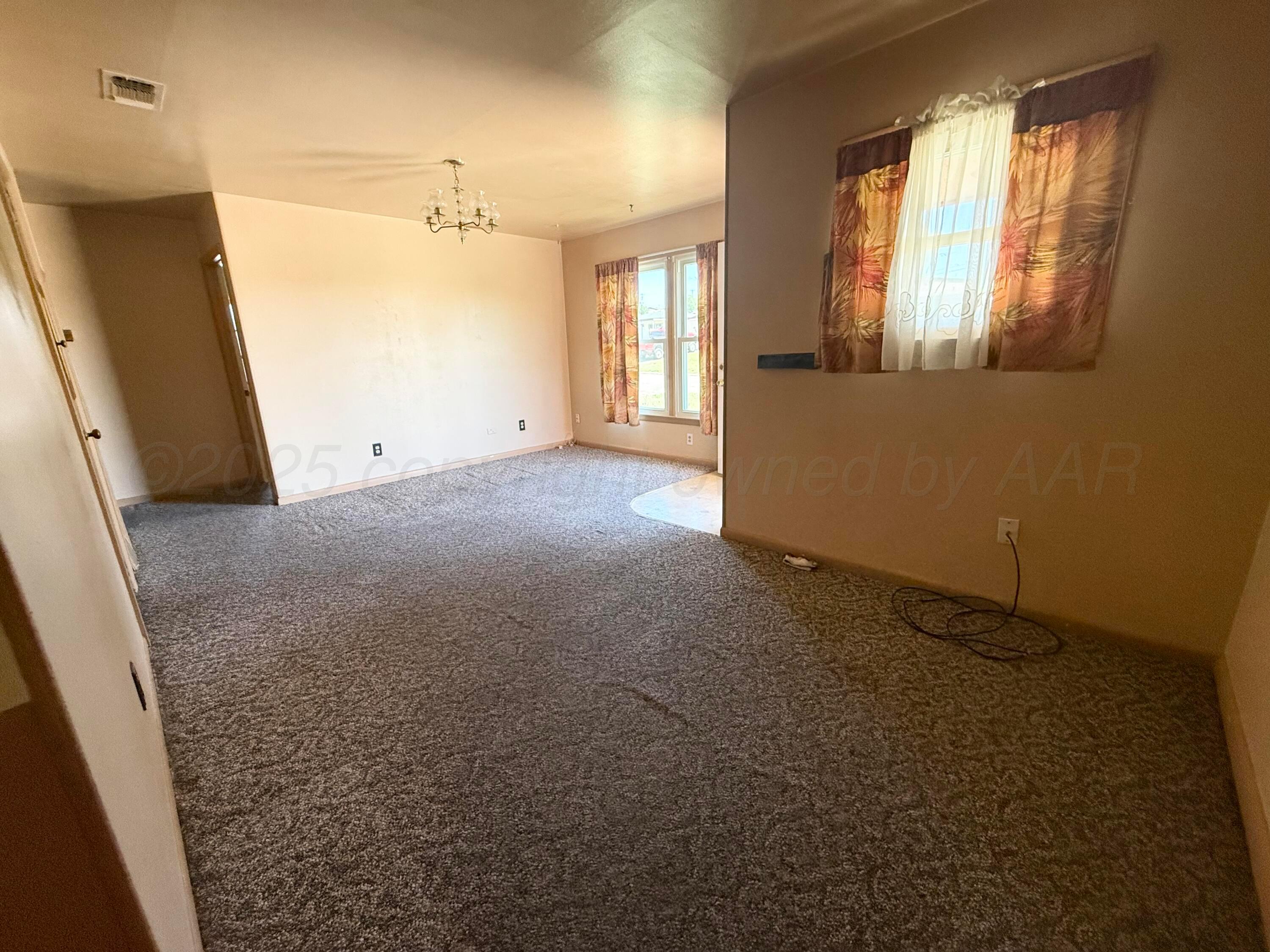 1030 Thrams Street Borger, TX 79007 - Photo 5 of 9 an empty room with windows