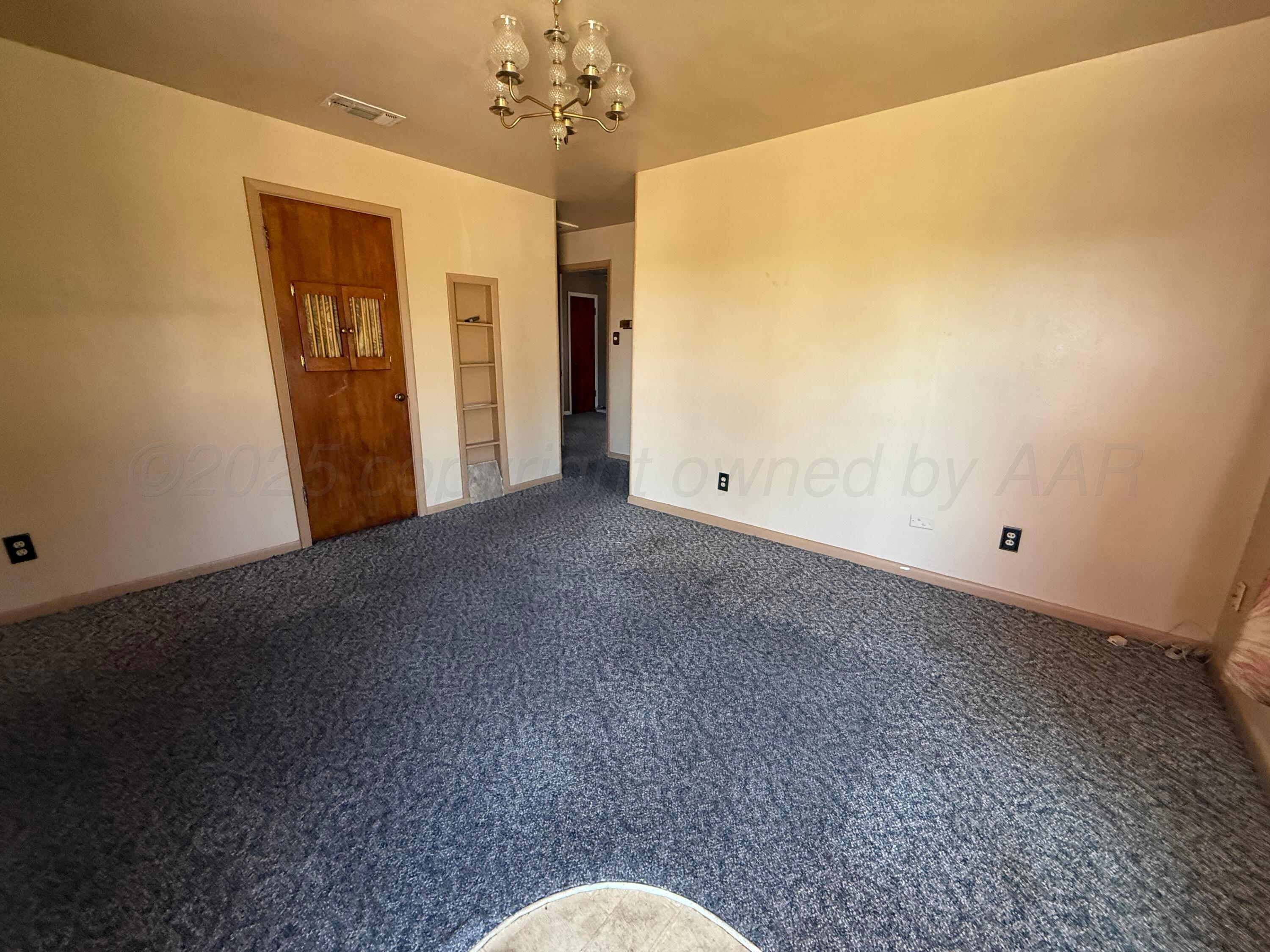 1030 Thrams Street Borger, TX 79007 - Photo 9 of 9 a view of a big room with windows