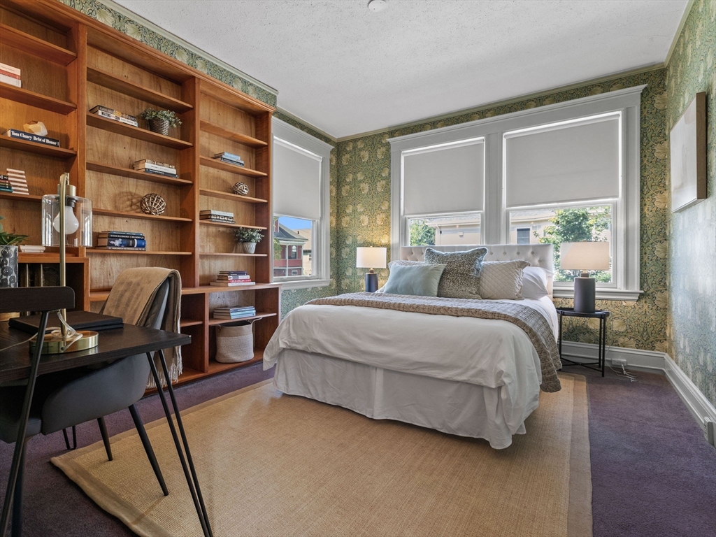 82 Perkins Street Boston, MA 02130 - Photo 15 of 31 a bedroom with a bed a table and a large window