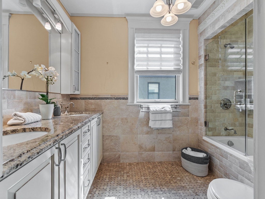 82 Perkins Street Boston, MA 02130 - Photo 16 of 31 a bathroom with a granite countertop toilet sink and mirror