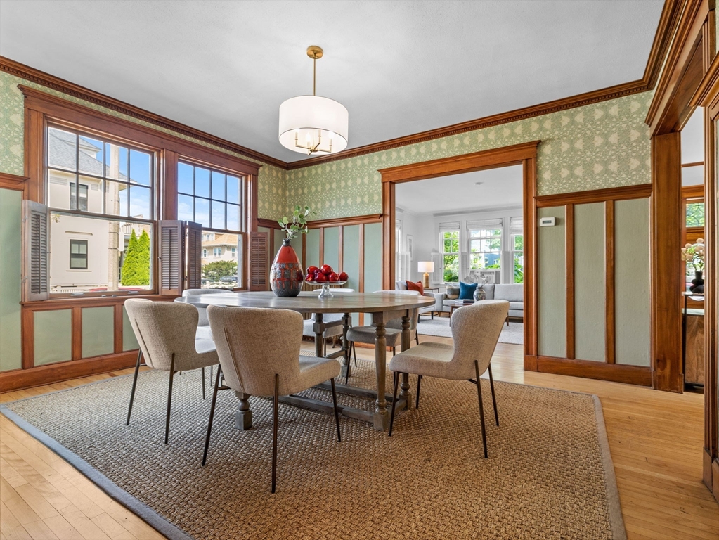 82 Perkins Street Boston, MA 02130 - Photo 7 of 31 a view of a dining room with furniture a chandelier and wooden floor