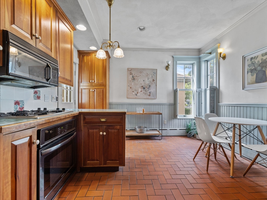 82 Perkins Street Boston, MA 02130 - Photo 9 of 31 a kitchen with granite countertop a stove a sink and a refrigerator