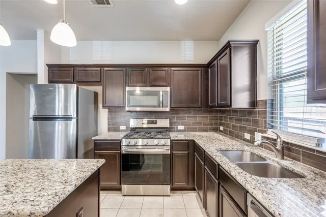 a kitchen with a sink stove and refrigerator
