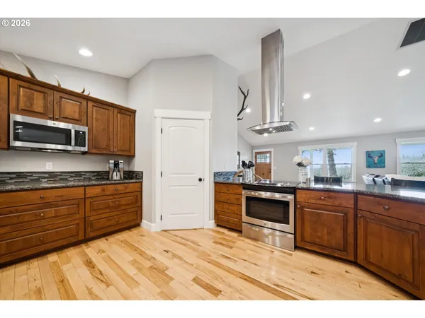 a kitchen with stainless steel appliances granite countertop a sink and cabinets