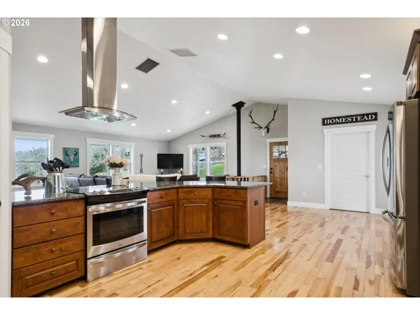 a kitchen with stainless steel appliances granite countertop a sink and cabinets