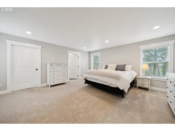 a spacious bedroom with a bed and a window