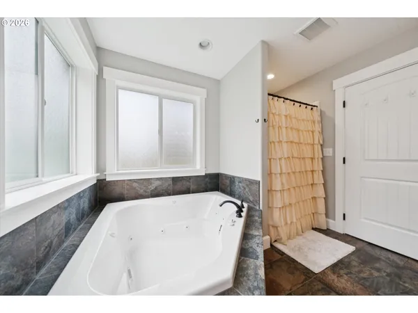 a bathroom with a bathtub and a shower