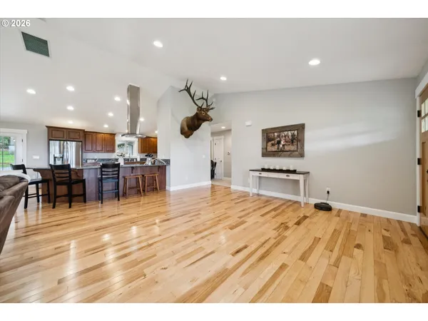 a room with lots of furniture and a view of kitchen