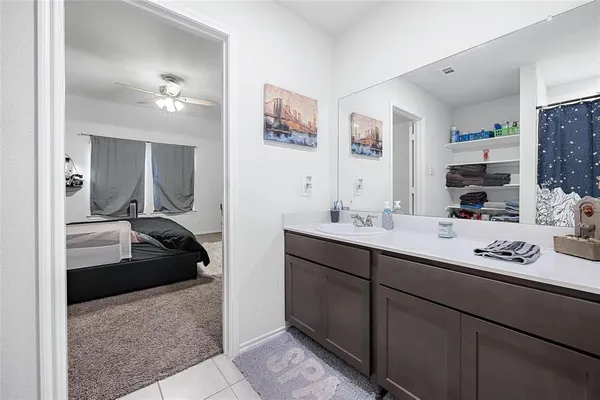 a en suite bathroom with double sink and a mirror