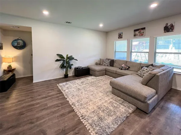 a living room with furniture window and wooden floor