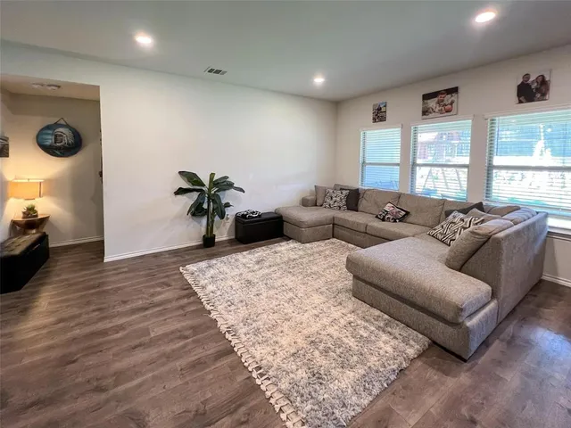 a living room with furniture window and wooden floor