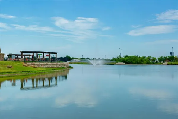 a swimming pool with barbeque oven in front of it