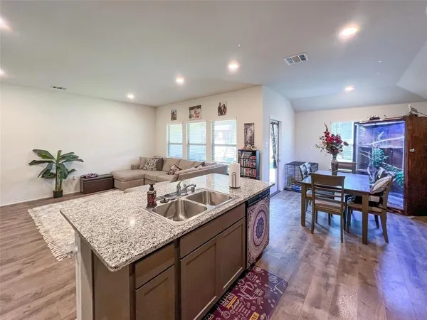 a kitchen with granite countertop kitchen island stainless steel appliances a table and chairs