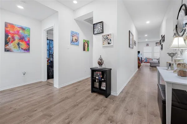 a view of a workspace with furniture and wooden floor
