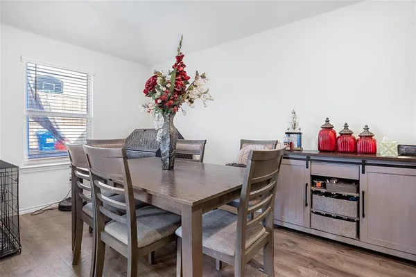 a view of a dining room with furniture and wooden floor