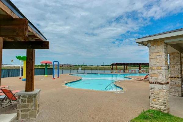swimming pool view with a seating space
