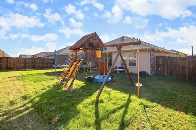 a view of a house with a yard patio and swimming pool