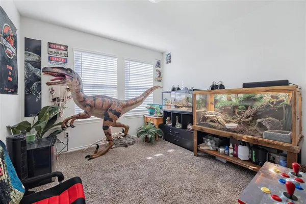 a living room with furniture a flat screen tv and a window