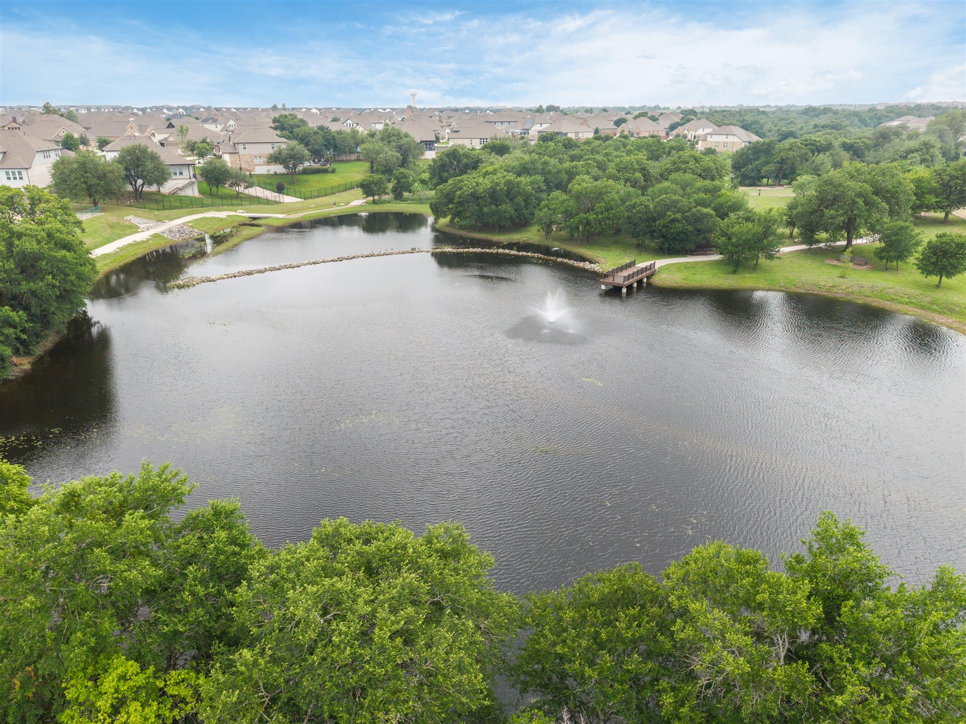 331 Mountain Valley Street Georgetown, TX 78628 - Photo 37 of 40 Community amenities: Expansive lake featuring a fountain, surrounded by green spaces and mature trees