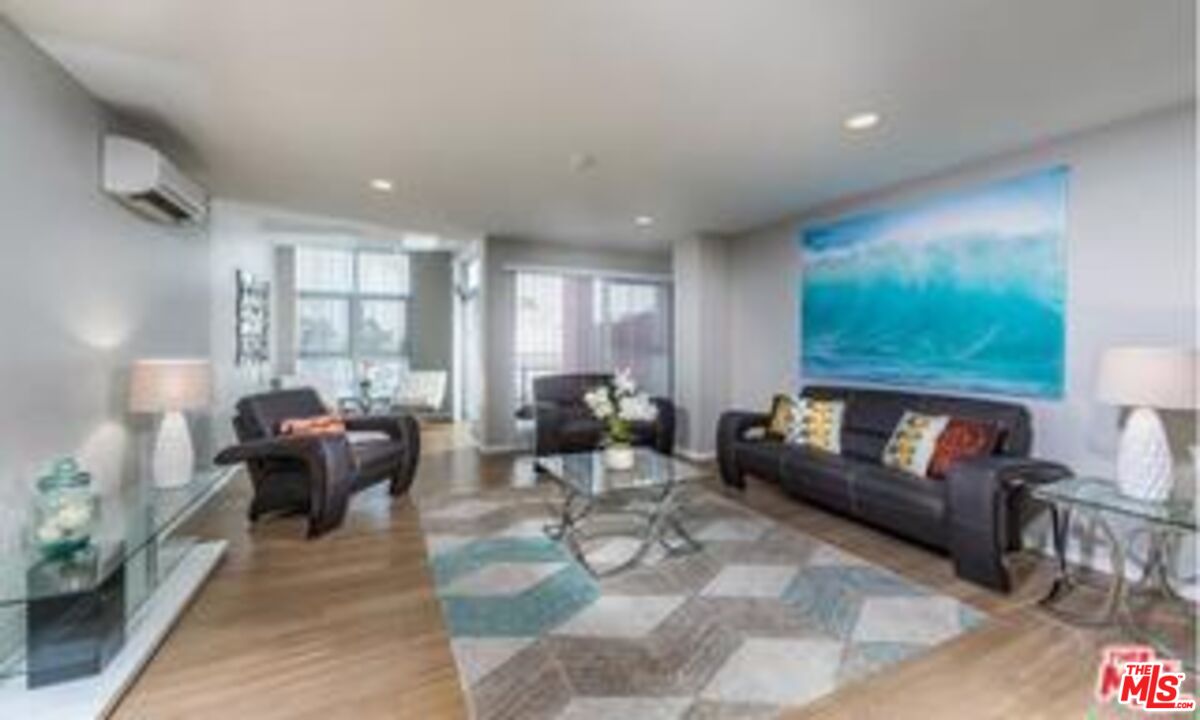 245 Pine Avenue, Unit 224 Long Beach, CA 90802 - Photo 6 of 15 a living room with furniture and a large window