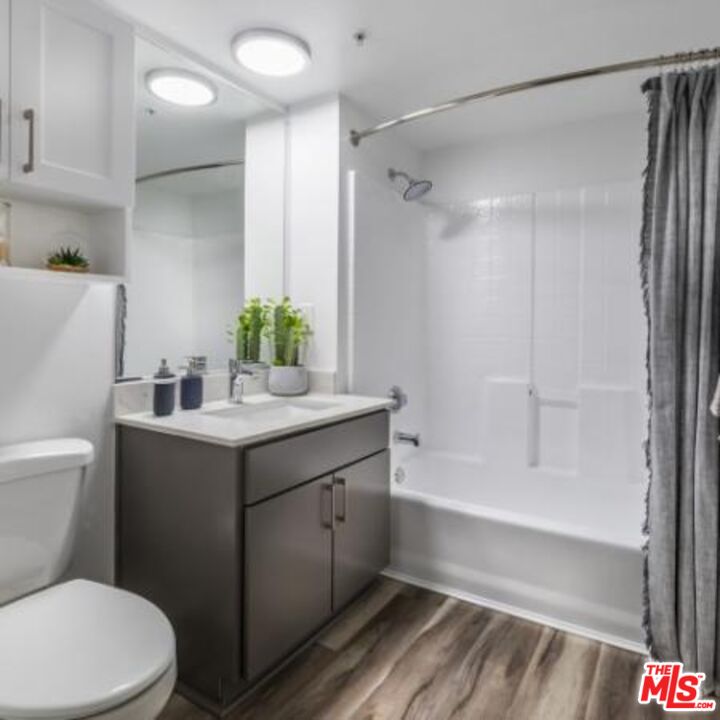 245 Pine Avenue, Unit 224 Long Beach, CA 90802 - Photo 9 of 15 a bathroom with a sink toilet and shower